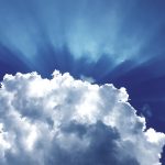 sun rays through white cumulus clouds